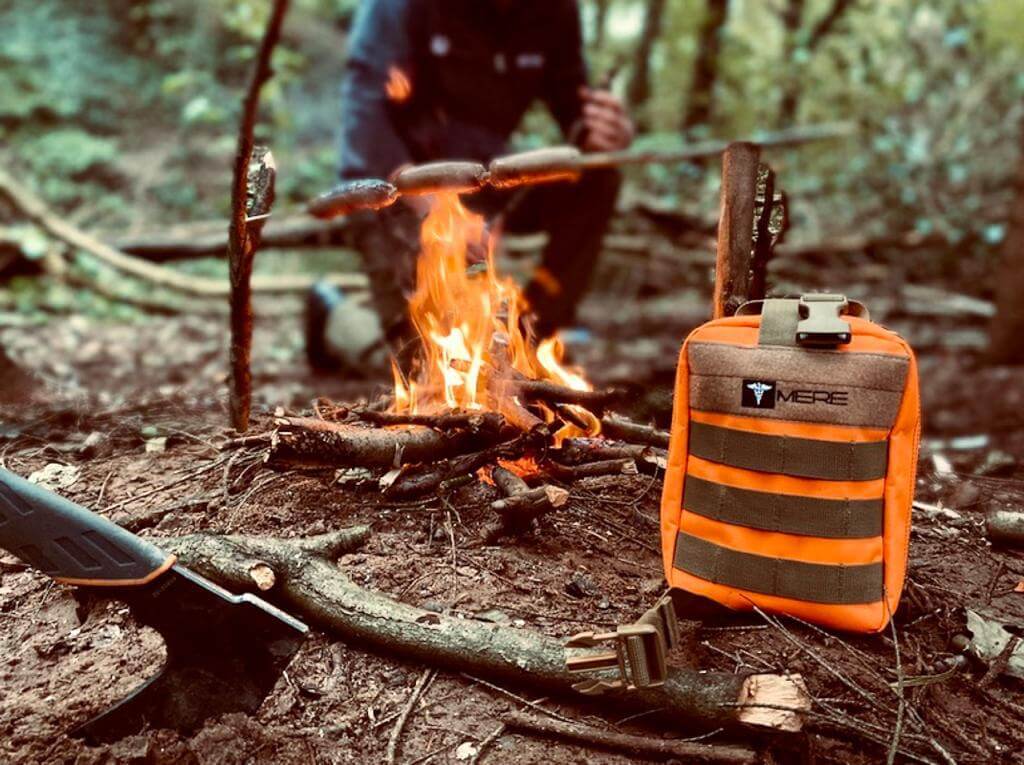 mere supplies orange bag in front of a fire